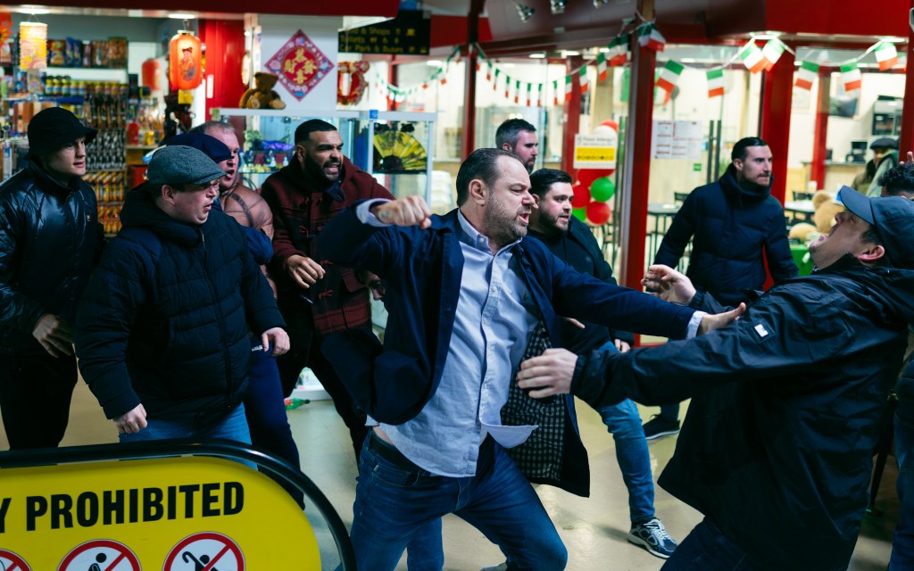 A group of men fighting outside of a restaurant in the film Marching Powder.